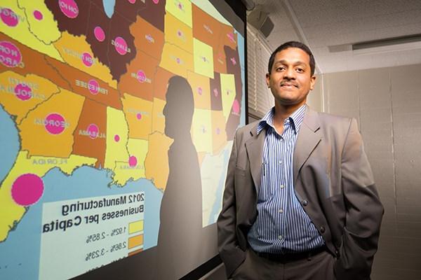 professor standing in front of a data map